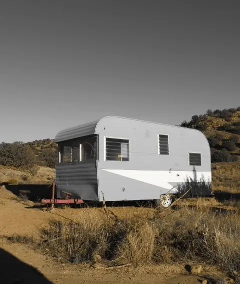 a small travel trailer parked at a boondocking site