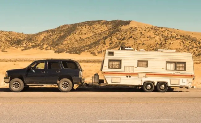 a old used travel trailer being towed