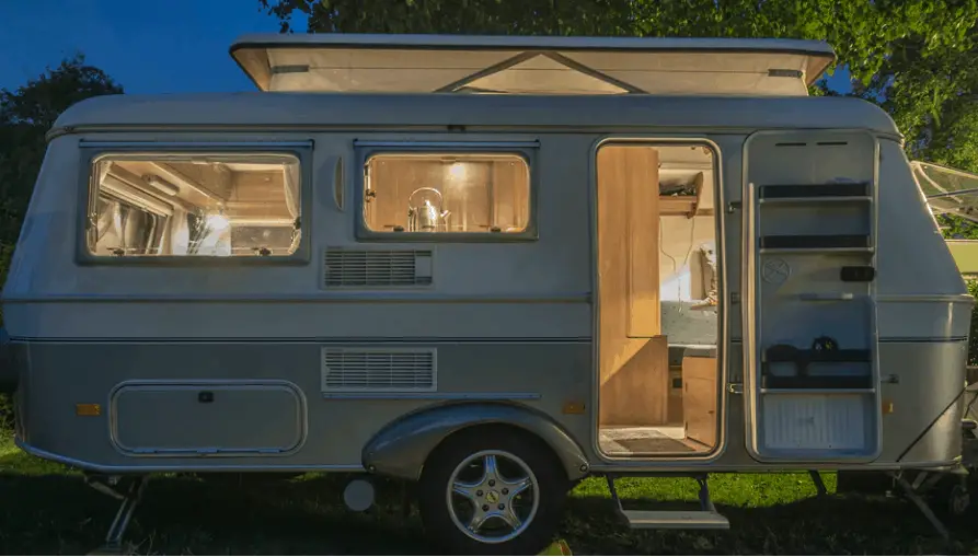 a travel trailer parked on grass