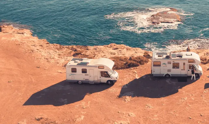 roof visible on two rvs parked near sea