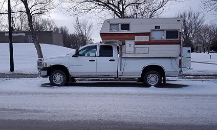 truck camper parked on the side of the road