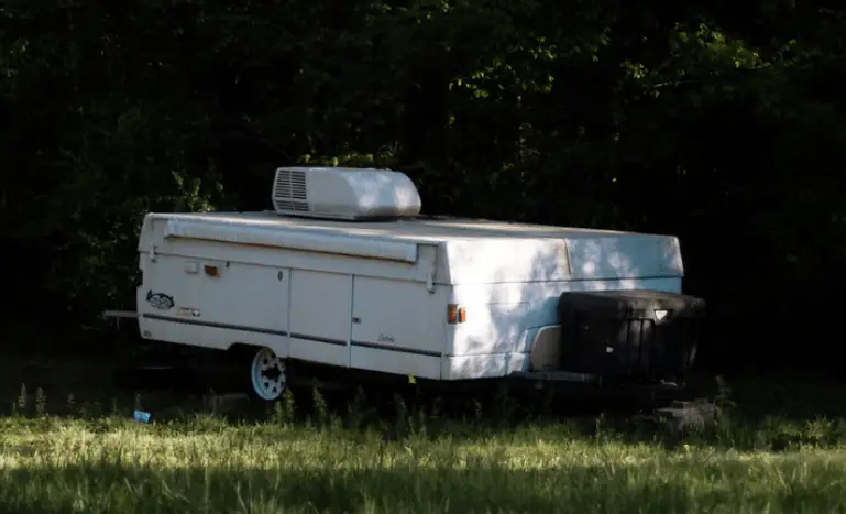 a pop up camper with air conditioner on it