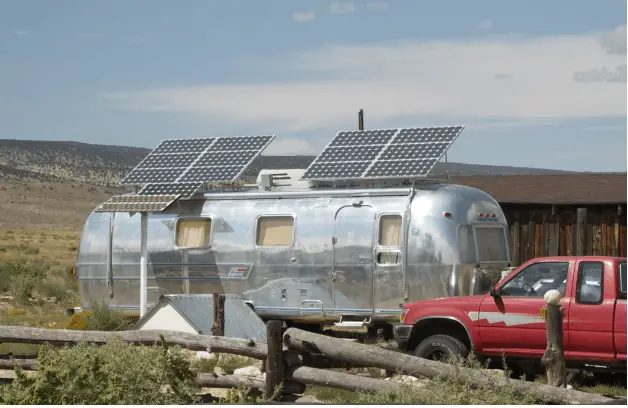 an airstream trailer with solar panels mounted on roof